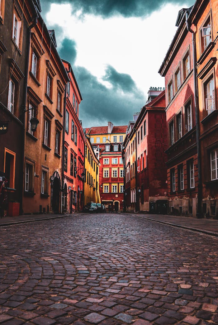 gallery-2 Dramatic view of cobblestone street in Warsaw's Old Town, showcasing colorful historic architecture.