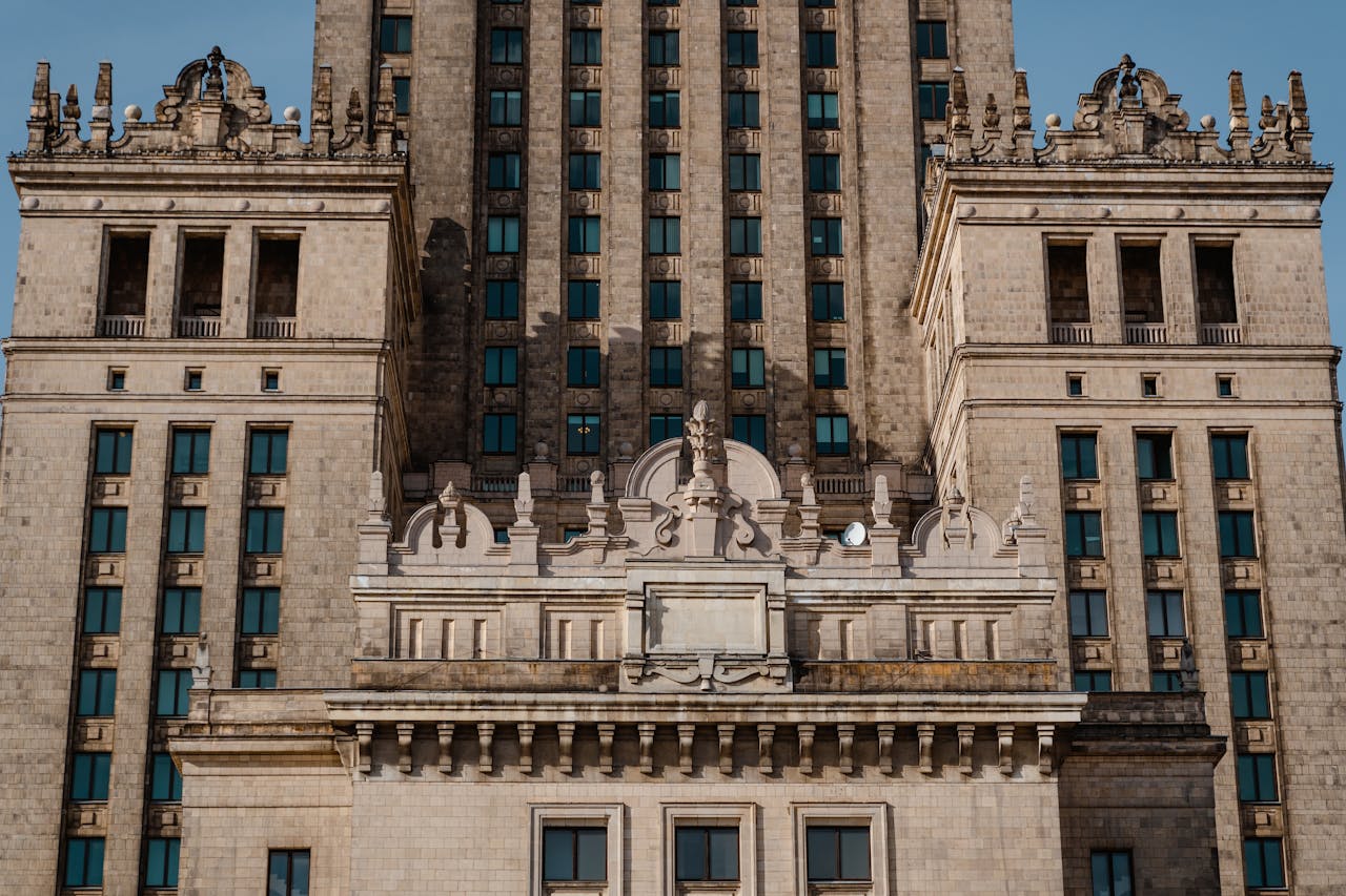 why-choose-us Detailed view of a neoclassical skyscraper facade in urban setting, highlighting architectural elements.